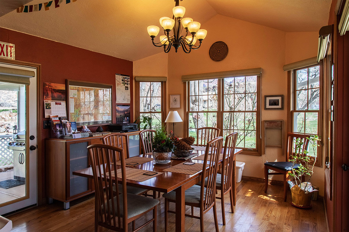 Dining room with wooden table and bay windows