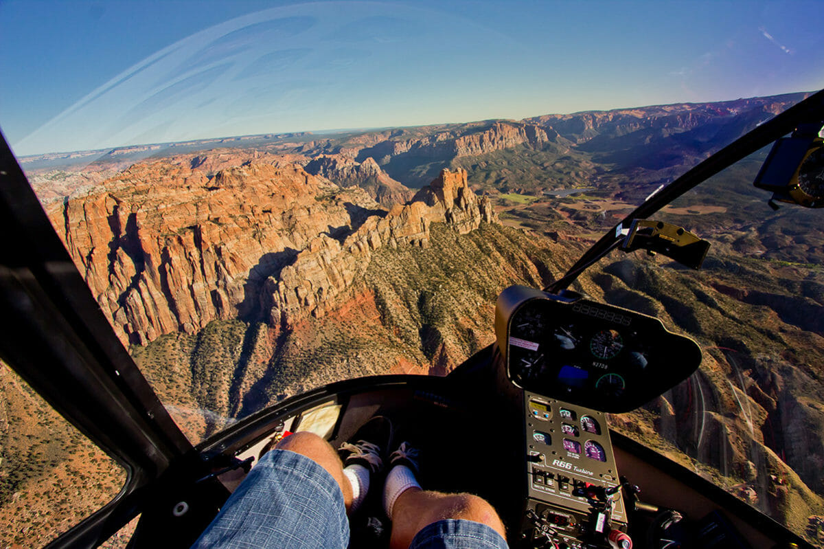 View from inside a helicopter of the rugged, rocky terrain.