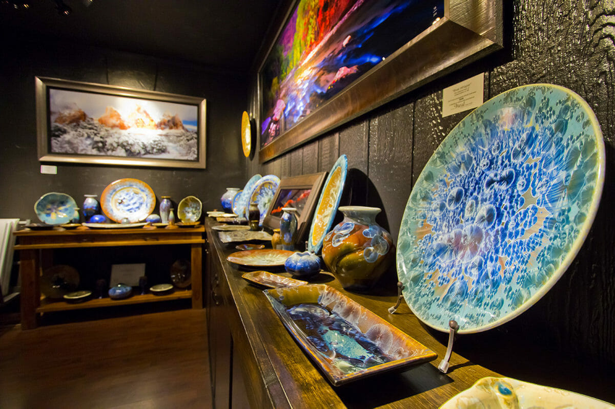 Close up view of pottery and paintings on display.