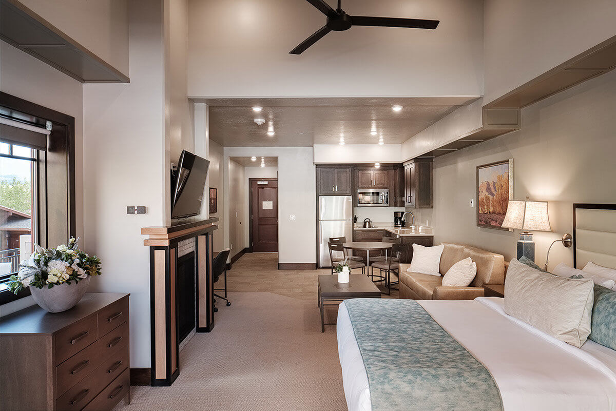 Suite with bed, seating area, and kitchen