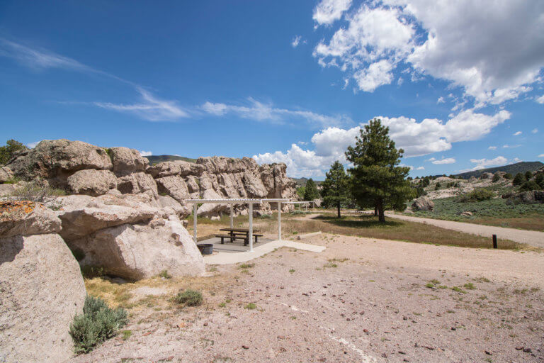 Campsite with white rock formations and pine trees