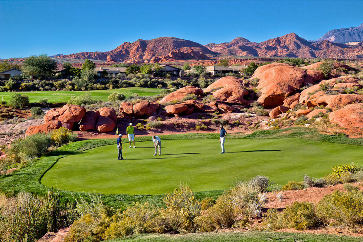 Foursome on the green at desert golf course