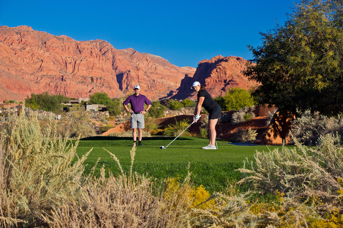 Couple golfing on desert course