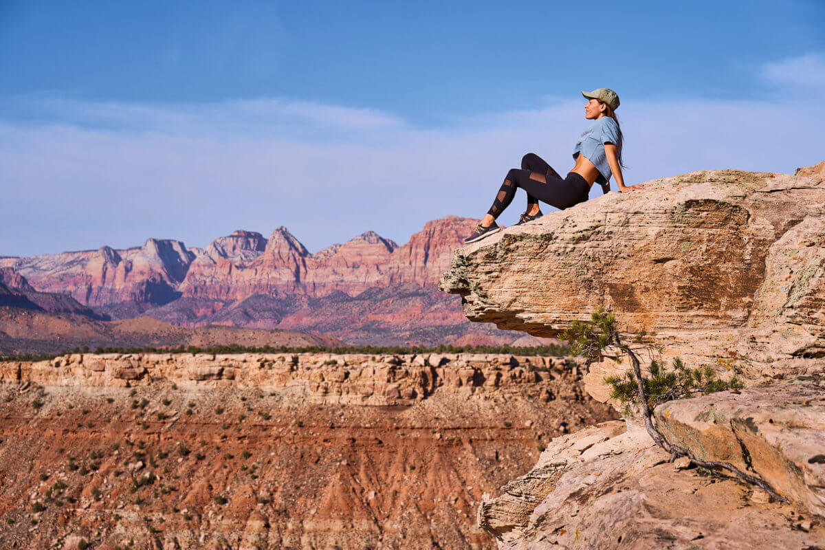 Woman sitting on cliff's edge