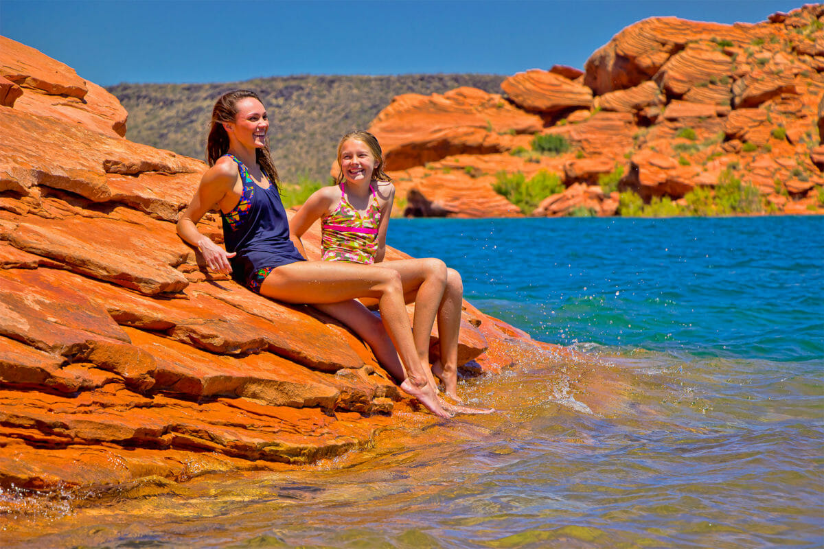 Two girls sun bathing at Sand Hollow