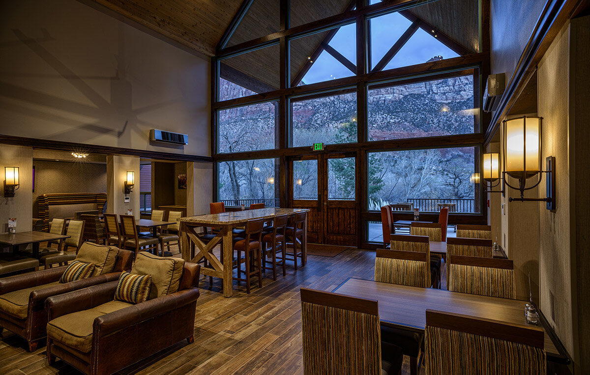 Lobby in mountain lodge with seating area and large windows