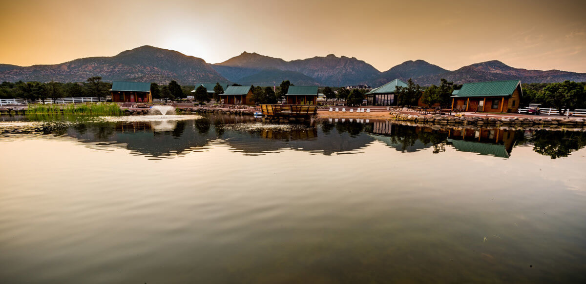 Small cabins surrounding mountain lake