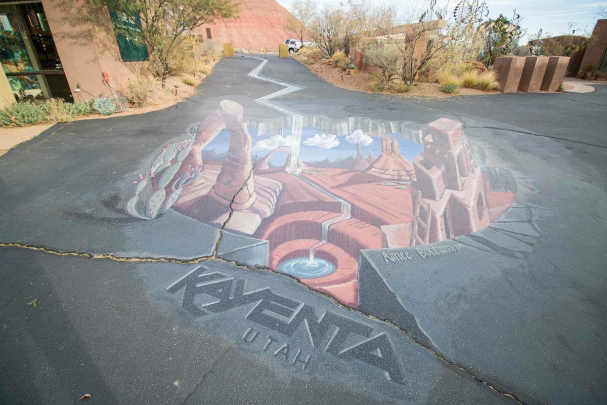3-dimensional chalk art on desert road.