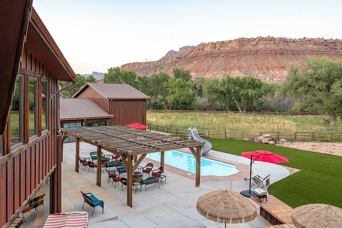 Cabin backyard with pool and mountains in backyard